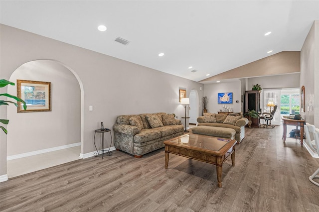 living room with lofted ceiling and light hardwood / wood-style flooring