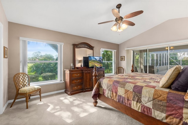 bedroom with vaulted ceiling, ceiling fan, light carpet, and multiple windows