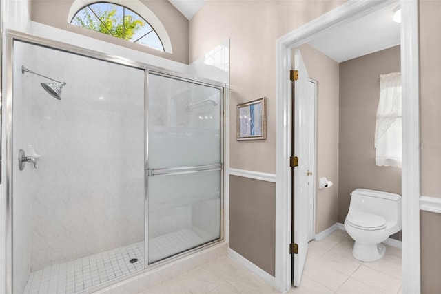 bathroom featuring toilet, tile patterned flooring, and walk in shower