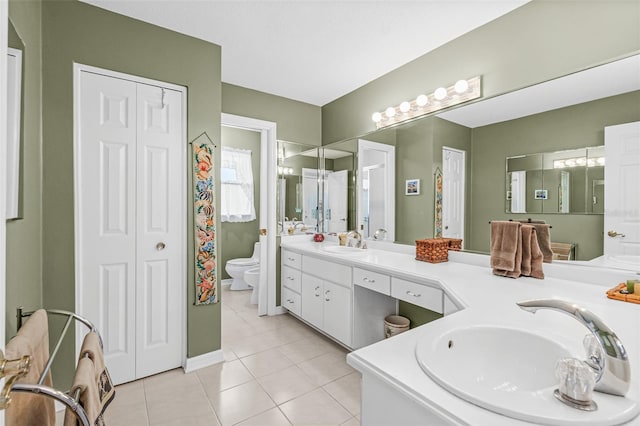 bathroom featuring toilet, vanity, and tile patterned floors