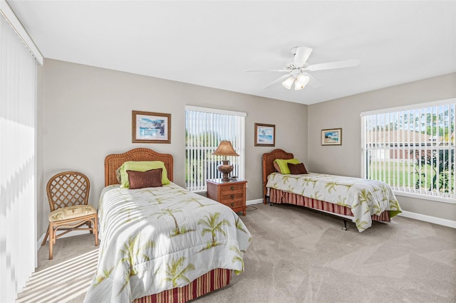 bedroom with ceiling fan and light carpet