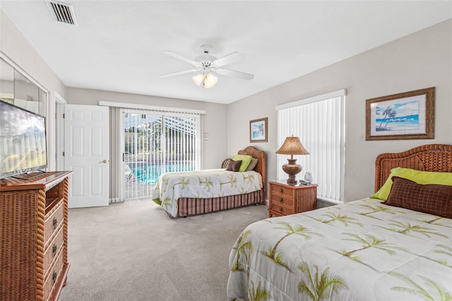 carpeted bedroom with ceiling fan and access to outside