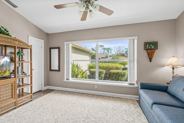 living area with ceiling fan and light wood-type flooring