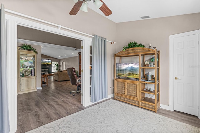 office area with vaulted ceiling, ceiling fan, and hardwood / wood-style flooring