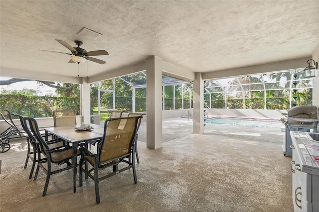 sunroom / solarium featuring a swimming pool and ceiling fan