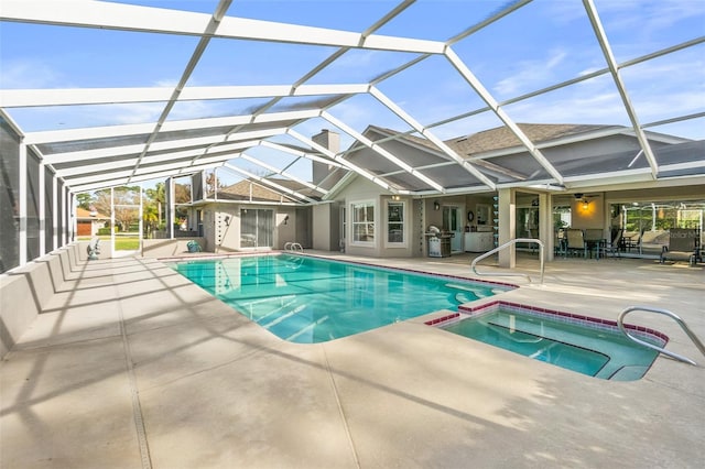 view of swimming pool with ceiling fan, a patio area, glass enclosure, and an in ground hot tub