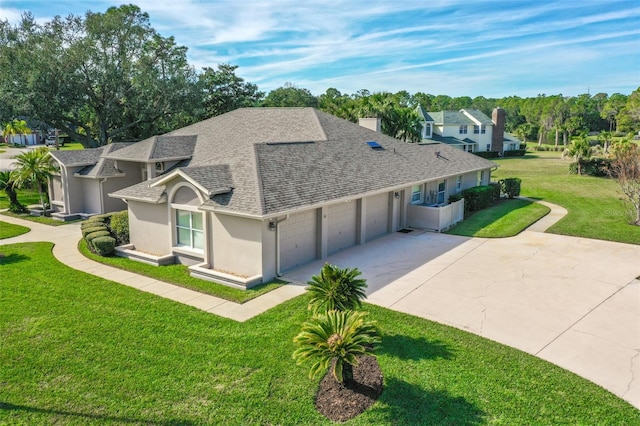 view of front of property featuring a front yard and a garage