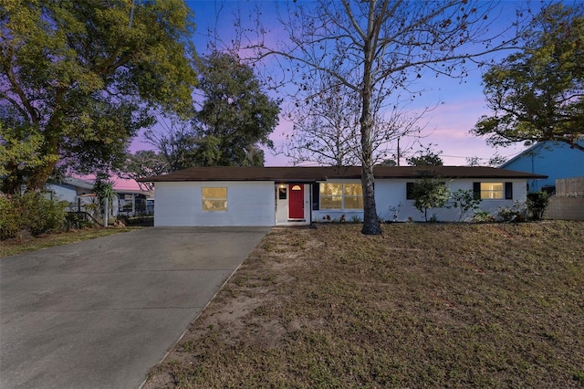 ranch-style home with a yard