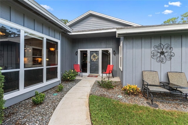 view of exterior entry with a patio area