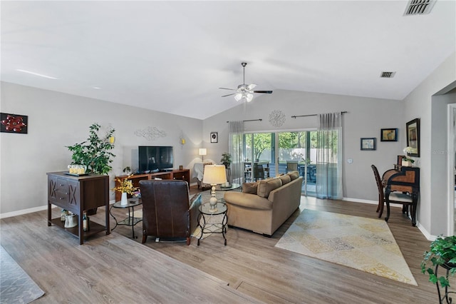 living room featuring ceiling fan, light hardwood / wood-style floors, and lofted ceiling