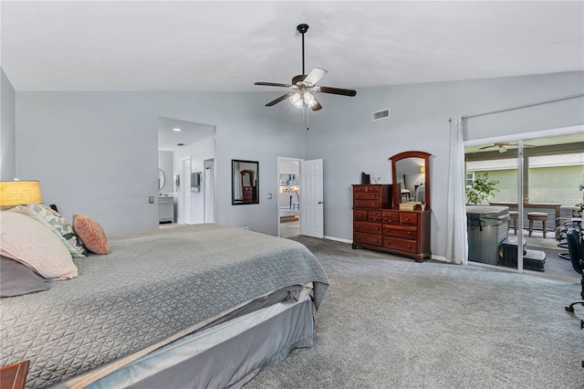 carpeted bedroom with ceiling fan, ensuite bathroom, and high vaulted ceiling