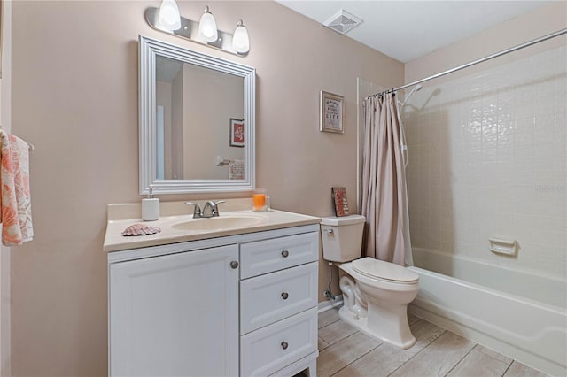 full bathroom with vanity, shower / bath combination with curtain, and toilet