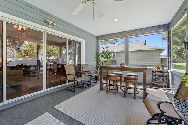 sunroom / solarium featuring ceiling fan