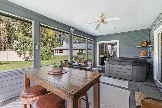 sunroom featuring ceiling fan and plenty of natural light