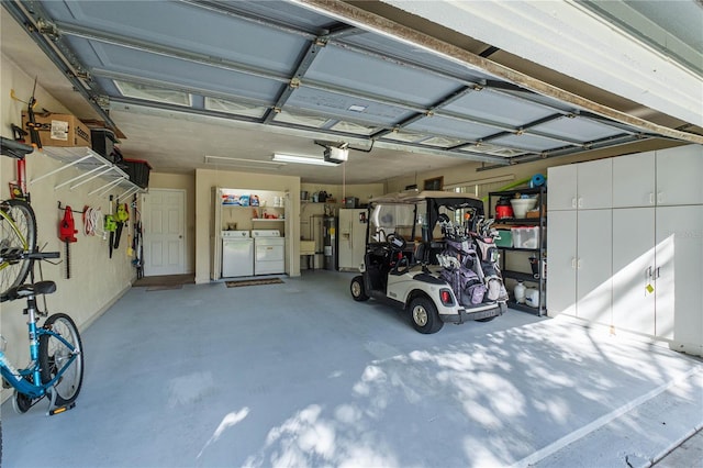 garage with washing machine and clothes dryer and a garage door opener