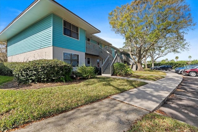 view of side of property featuring a yard