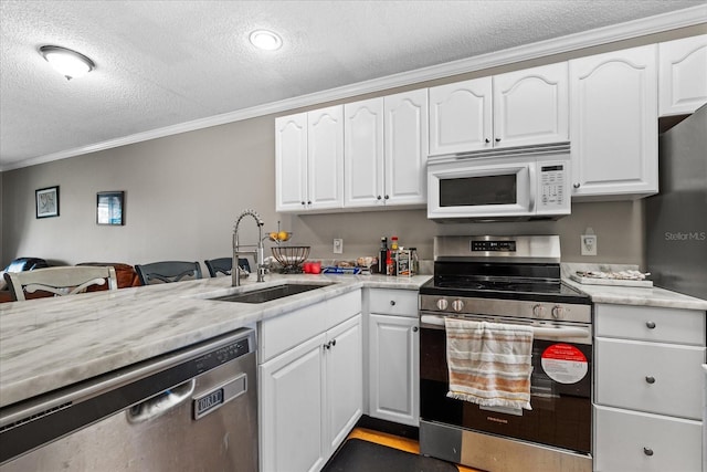 kitchen with white cabinets, sink, appliances with stainless steel finishes, and a textured ceiling