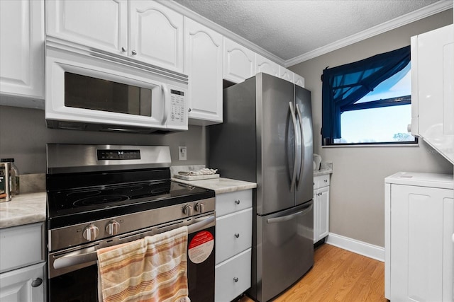 kitchen with a textured ceiling, stainless steel appliances, white cabinetry, and crown molding