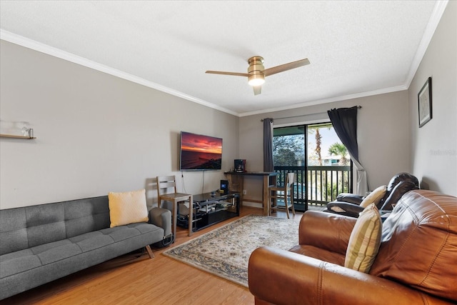 living room featuring a textured ceiling, hardwood / wood-style flooring, ceiling fan, and crown molding