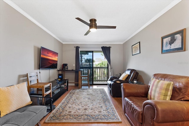 living room with hardwood / wood-style flooring, ceiling fan, and crown molding