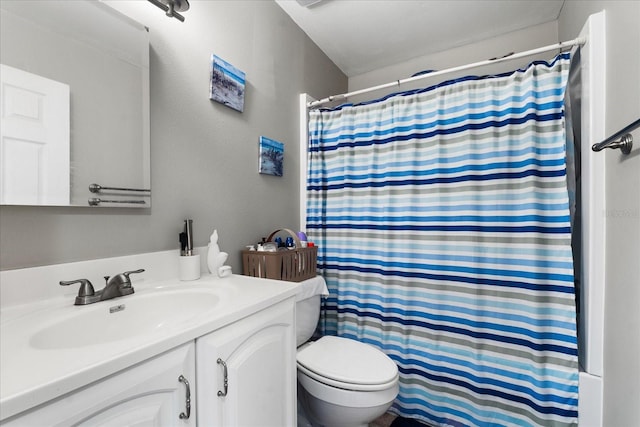 bathroom with vanity, toilet, and walk in shower