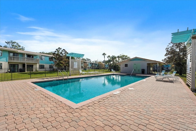 view of swimming pool with a lawn and a patio area