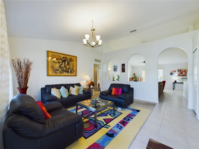 living room featuring light tile patterned floors, ceiling fan with notable chandelier, and vaulted ceiling