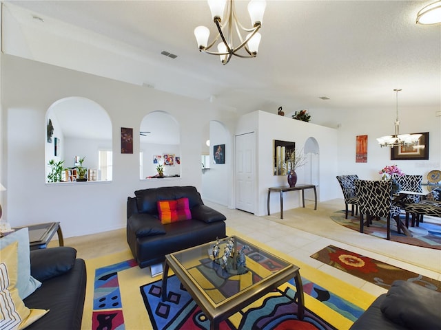 living room featuring light tile patterned floors, visible vents, arched walkways, vaulted ceiling, and a notable chandelier