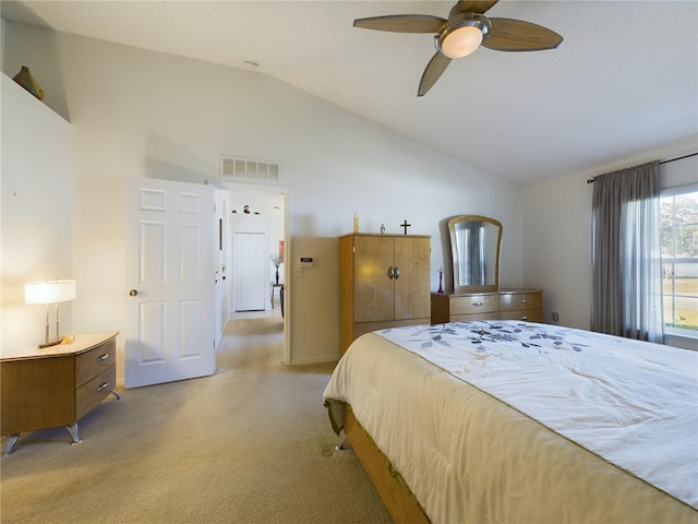 bedroom featuring vaulted ceiling, light carpet, visible vents, and a ceiling fan