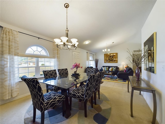 dining room featuring vaulted ceiling, a wealth of natural light, light colored carpet, and a notable chandelier