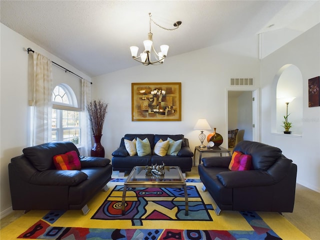 living area with vaulted ceiling, arched walkways, visible vents, and a notable chandelier