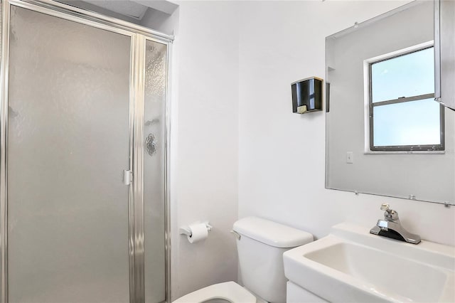 bathroom with toilet, sink, and walk in shower