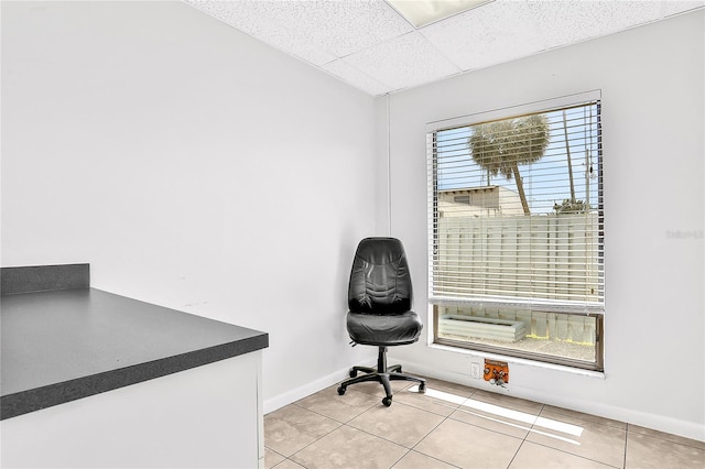 tiled office space with a drop ceiling