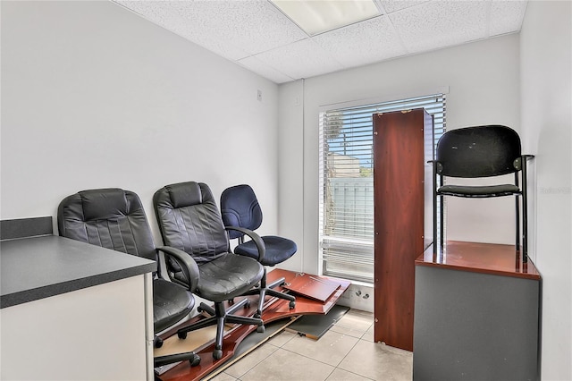 tiled office with a paneled ceiling