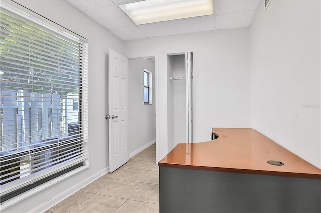 office area featuring a paneled ceiling and light tile patterned flooring