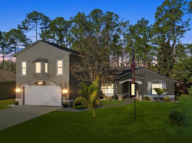 view of front facade featuring a lawn and a garage