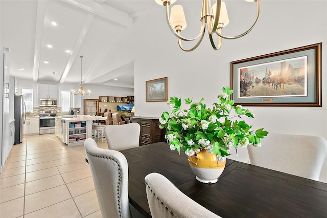 dining area with light tile patterned floors, lofted ceiling with beams, an inviting chandelier, and sink