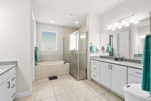 bathroom featuring tile patterned flooring, shower with separate bathtub, and vanity