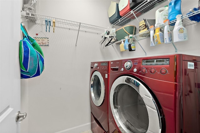 clothes washing area with separate washer and dryer