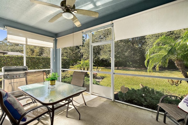 sunroom featuring ceiling fan