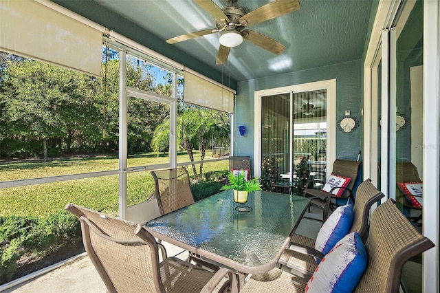 sunroom / solarium featuring plenty of natural light and ceiling fan