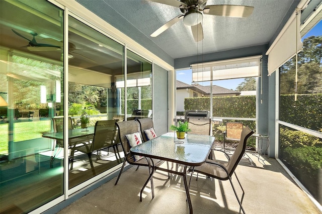 sunroom featuring ceiling fan