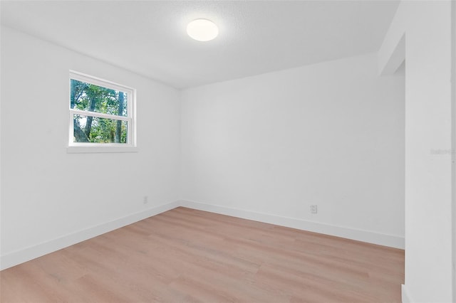 spare room with light hardwood / wood-style flooring