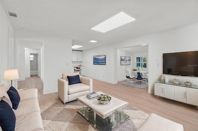 living room with light hardwood / wood-style flooring