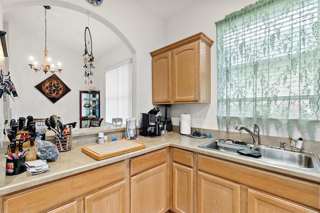 kitchen featuring light brown cabinets, sink, a wealth of natural light, and an inviting chandelier