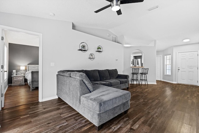 living room featuring dark hardwood / wood-style floors, ceiling fan, and lofted ceiling