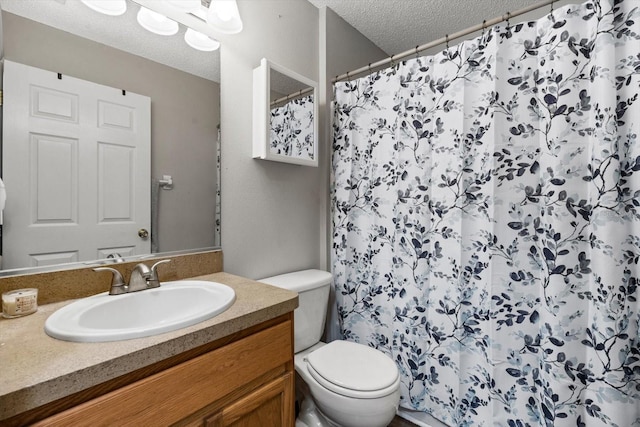 bathroom featuring vanity, a textured ceiling, toilet, and curtained shower