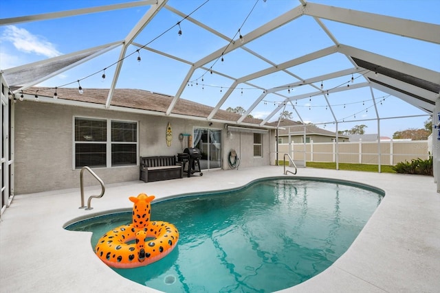 view of swimming pool with glass enclosure, a grill, and a patio