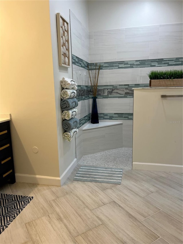 bathroom featuring vanity and a tile shower