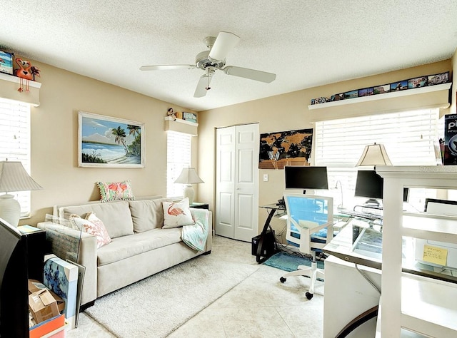 office area featuring ceiling fan, a textured ceiling, and a wealth of natural light